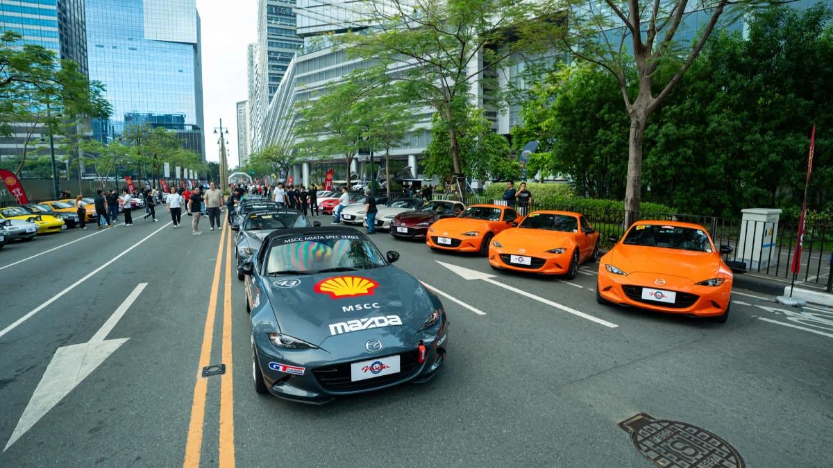 Tourists taking photos of luxury sports cars during car meets in Bonifacio Global City