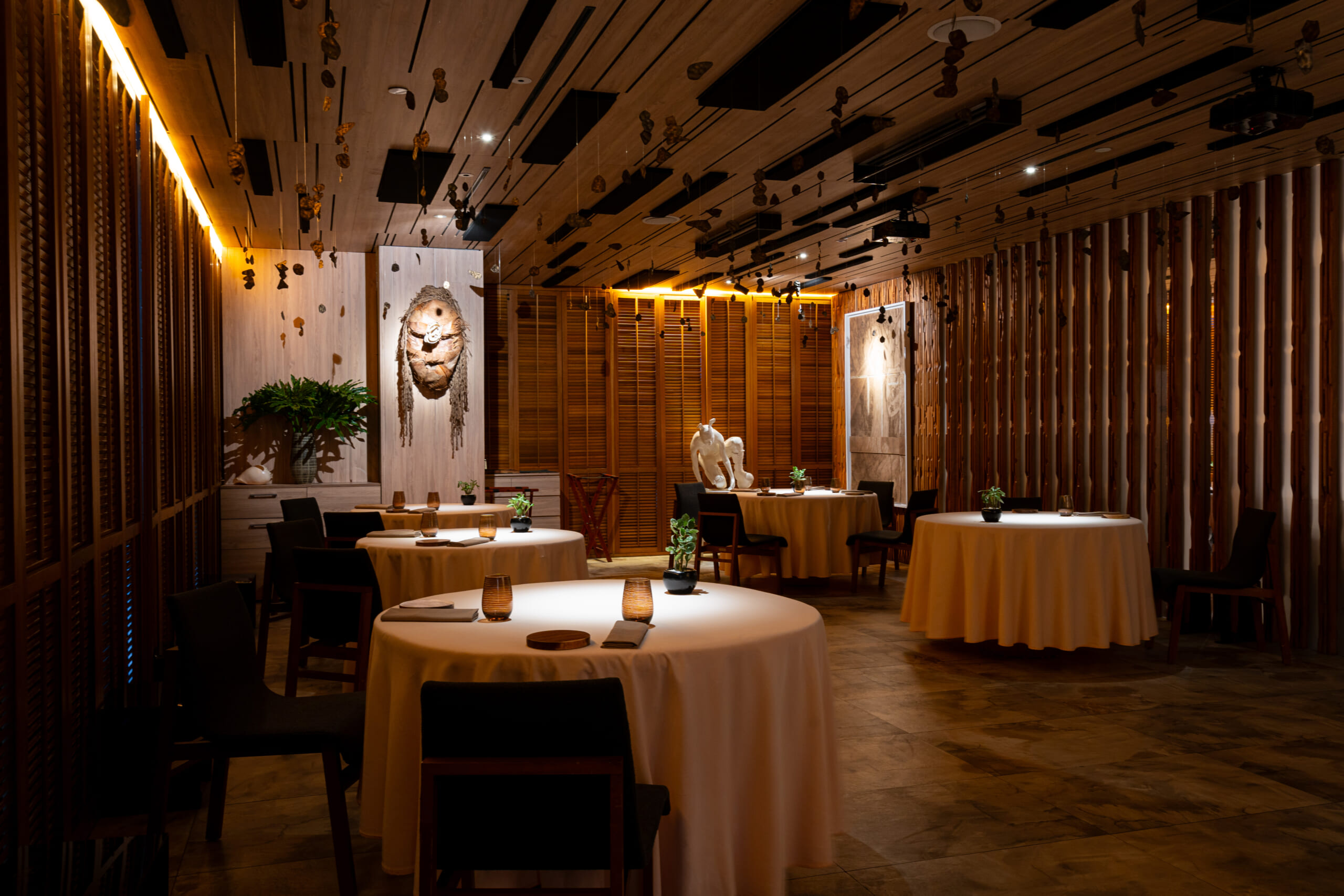 Tourists experiencing luxury fine dining, artistic food presentation, elegant interiors, and multi-course tasting menus inside Gallery by Chele restaurant in Bonifacio Global City