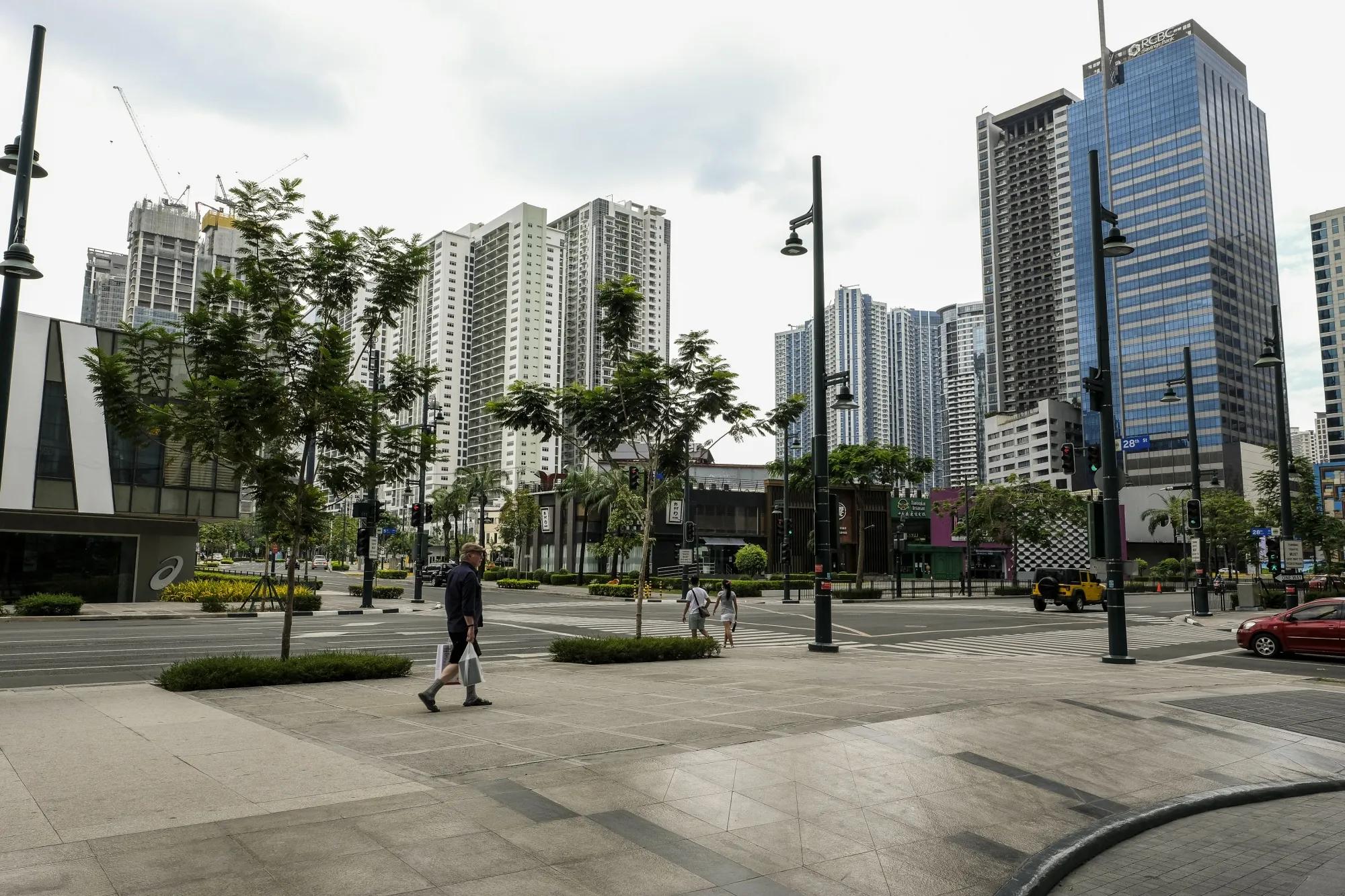 Quiet street with modern buildings and fewer crowds in BGC