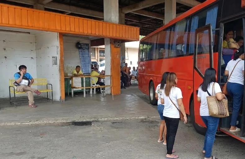 Passengers getting on the bus in the morning.