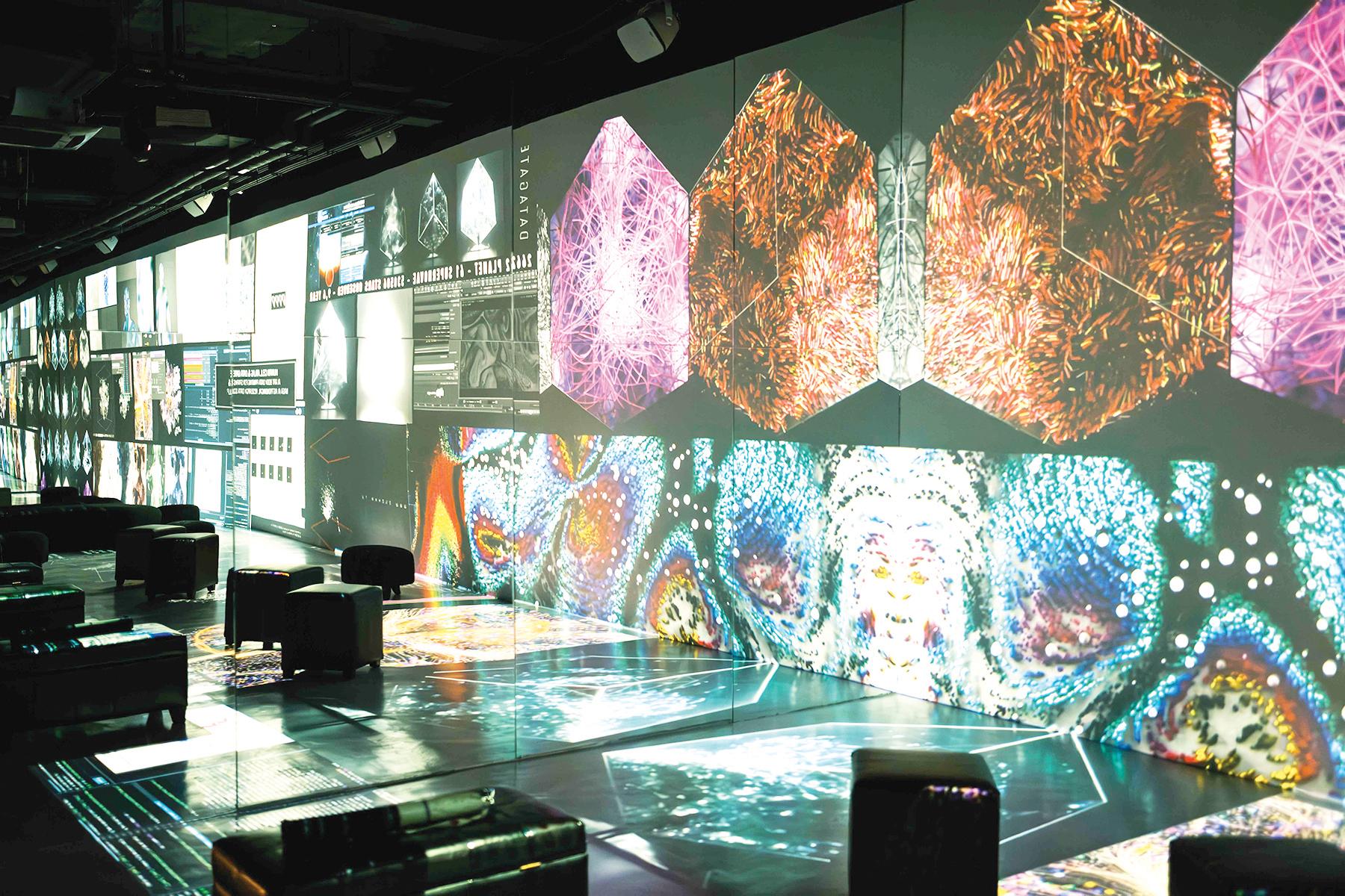 Visitors using VR headsets and interactive tech exhibits in a museum