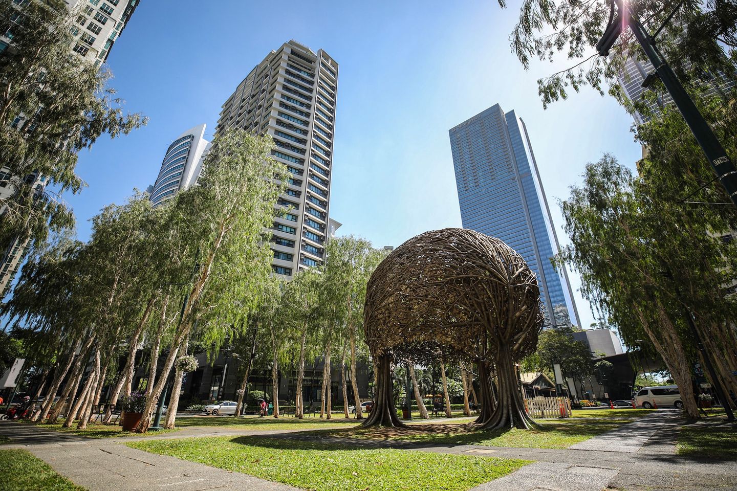 Tourists relaxing and walking around Burgos Circle Park in Bonifacio Global City like this