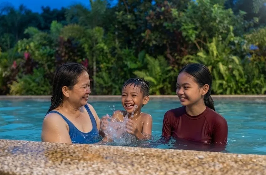 A family enjoying a dip at the pool.
