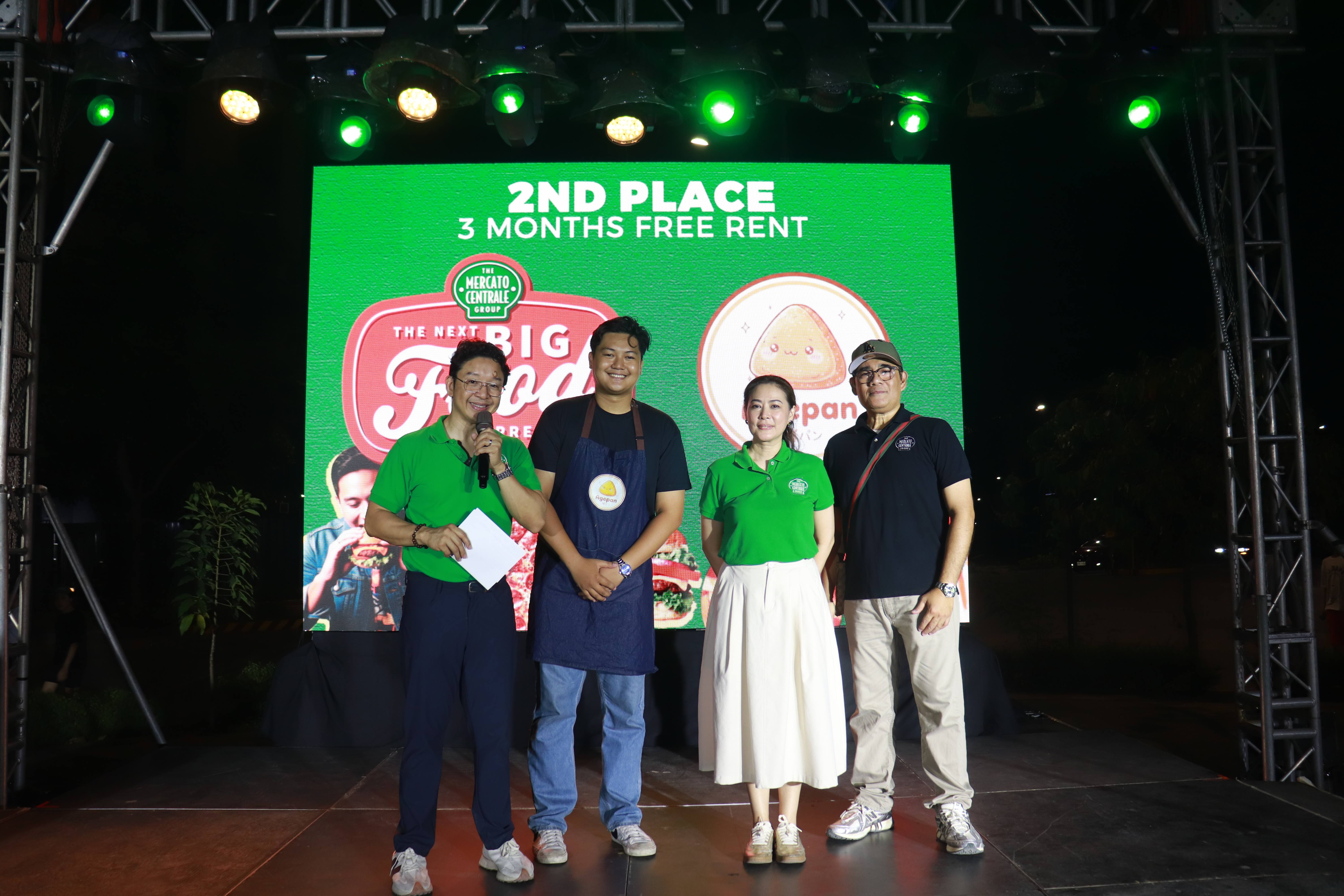 From left to right: RJ Ledesma, CEO of Mercato Centrale; Simon Louis Dayrit, Agepan Owner; Vanessa Ledesma, President of Mercato Centrale; and Daniel Aguilar, General Manager of Mercato Centrale; pose for a photo onstage as Agepan Japanese Fried Bread receives its award as the NBFE 2026 2nd Place Winner.