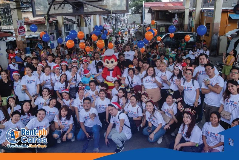 Community Christmas event with volunteers, children, and the Jollibee mascot