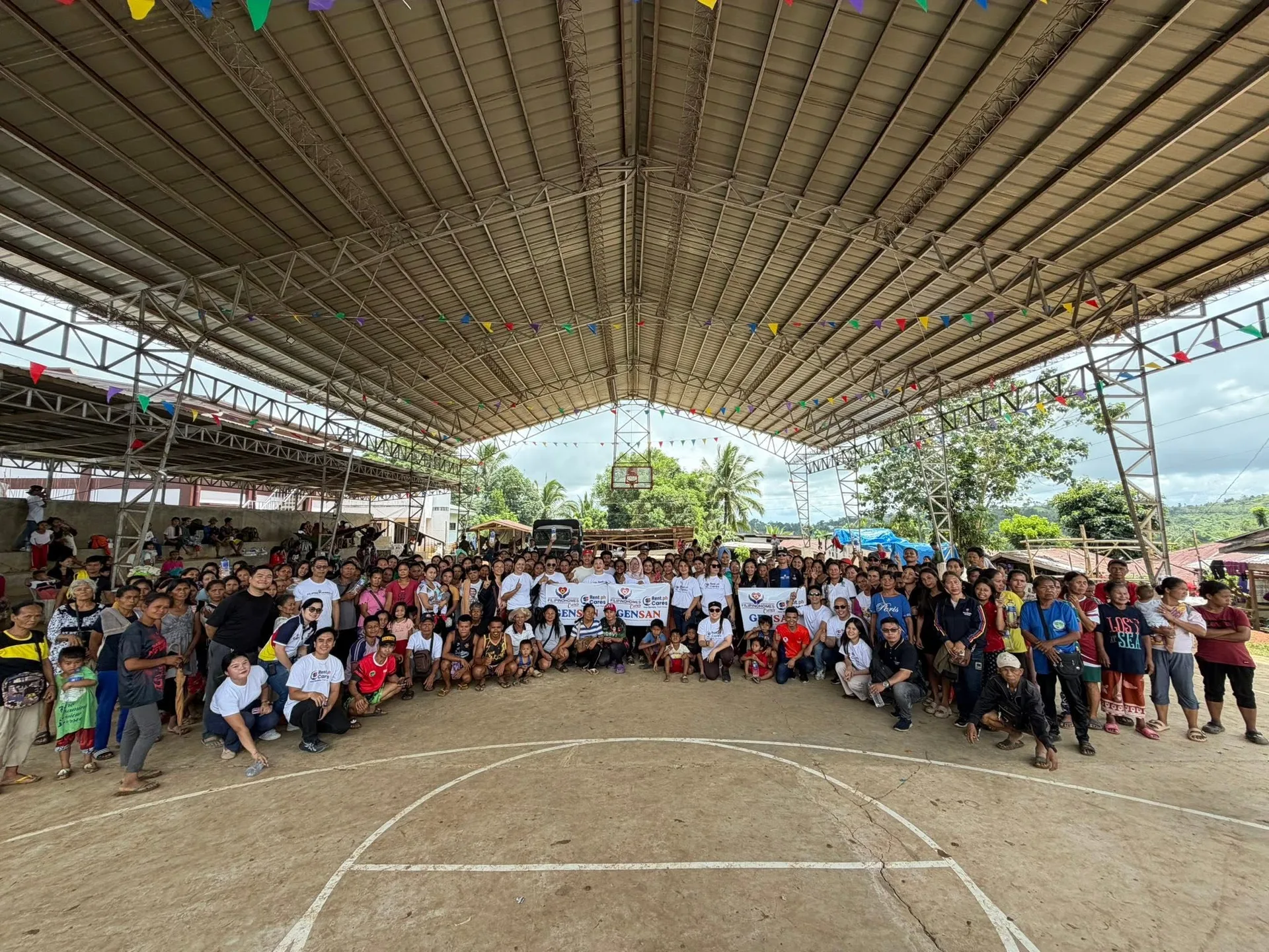 The whole barangay gathered under a covered court to receive relief goods
