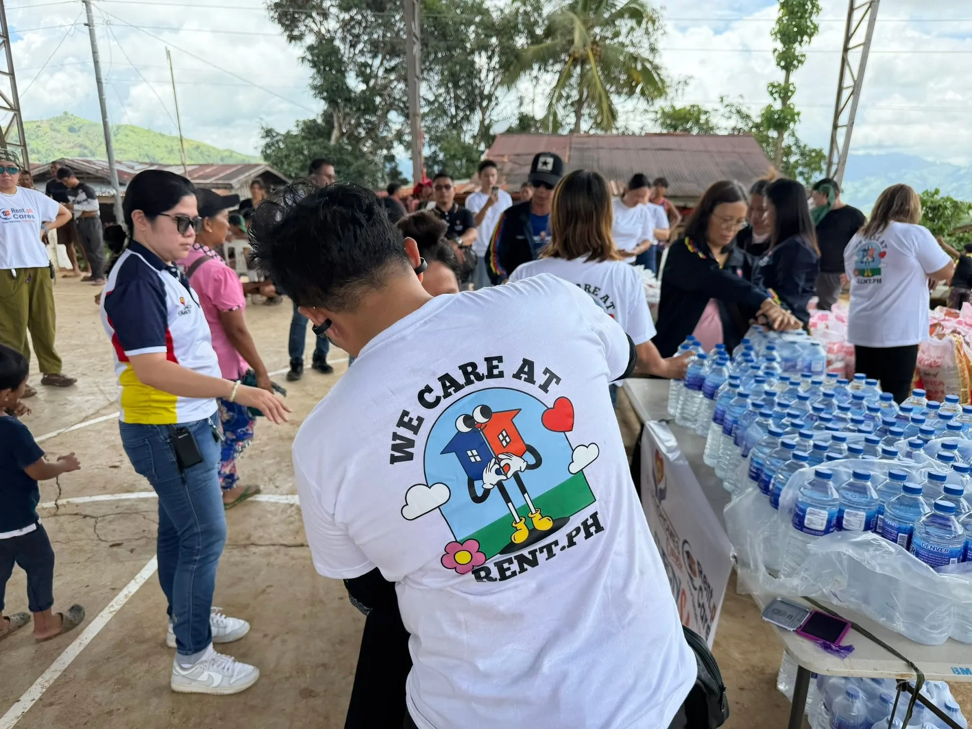Volunteers handing out bottled water in a mountain community