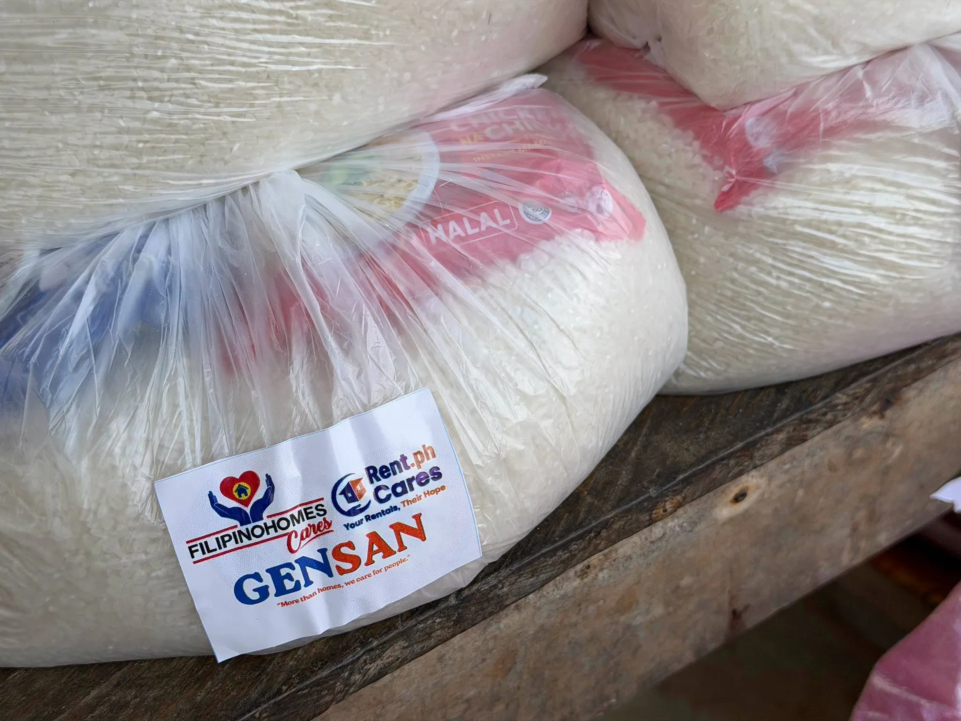 Close-up of a labeled relief goods pack reading 'More than homes, we care for people'